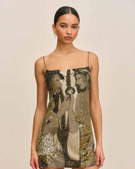 A printed dress photographed against a plain wall.